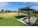 Dog park featuring large open green space, shaded structure with benches and a black iron fence at 13922 Old Creek Ct, Parrish, FL 34219