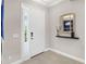 Bright foyer with a stylish mirror and a view into a blue dining area at 13922 Old Creek Ct, Parrish, FL 34219