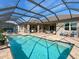 Enjoy the Florida sunshine in this screened-in pool area with ample space for lounging and entertaining at 13922 Old Creek Ct, Parrish, FL 34219