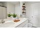 Bathroom features a double sink vanity, floating shelves, and modern fixtures at 14180 Crimson Ave, Bradenton, FL 34211