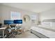 Well-lit bedroom featuring a work space, a round mirror, and large windows at 14180 Crimson Ave, Bradenton, FL 34211