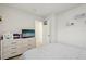 Neutral bedroom with dresser, TV, and 'Love' shelf decor, plus mini basketball hoop at 14180 Crimson Ave, Bradenton, FL 34211