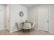 A modern round wood table with four chairs sits beneath a decorative clock in this cozy dining space at 14180 Crimson Ave, Bradenton, FL 34211