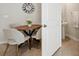 Bright dining area features a round table and stylish chairs adjacent to a bathroom at 14180 Crimson Ave, Bradenton, FL 34211