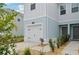 The front of a two-story townhome featuring a garage and small front yard with landscaping at 14180 Crimson Ave, Bradenton, FL 34211