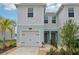 Charming townhouse with a white garage door, light blue trim, and well-maintained landscaping at 14180 Crimson Ave, Bradenton, FL 34211