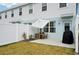 View of the patio area with an umbrella, seating, grill, and white fence for outdoor enjoyment at 14180 Crimson Ave, Bradenton, FL 34211