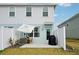 A cozy patio setup includes a white umbrella, outdoor chairs, and a grill, perfect for relaxing outdoors at 14180 Crimson Ave, Bradenton, FL 34211