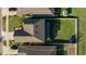 Aerial view of a fenced backyard with green grass, along with view of the home and neighborhood at 14318 Fissore Blvd, Wimauma, FL 33598