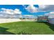 A spacious backyard with a trampoline, a fence, and a large grassy area at 14318 Fissore Blvd, Wimauma, FL 33598