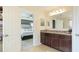 Neutral bathroom featuring granite countertops, a view into the bedroom, and bright lighting at 14318 Fissore Blvd, Wimauma, FL 33598