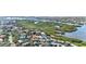 Aerial view showing home amid mature trees and convenient access to the open bay at 1447 Landings Cir # 68, Sarasota, FL 34231