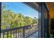 Private balcony view with mature landscaping and a glimpse of the surrounding neighborhood at 1447 Landings Cir # 68, Sarasota, FL 34231