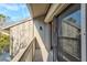 Exterior view of a private balcony featuring wood decking and a sliding glass door, providing access to the outdoors at 1447 Landings Cir # 68, Sarasota, FL 34231