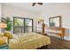 Cozy bedroom featuring a sliding glass door that opens to a private deck, and stylish wood laminate flooring at 1447 Landings Cir # 68, Sarasota, FL 34231