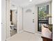 Bright foyer with a white door, stylish tile flooring, and a view into the half bathroom at 1447 Landings Cir # 68, Sarasota, FL 34231