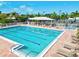 A large community pool, many lounge chairs, tennis court and spa for residents' enjoyment at 1447 Landings Cir # 68, Sarasota, FL 34231