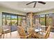 Inviting sitting area with a glass table, wicker chairs, and sliding glass doors to a patio at 1447 Landings Cir # 68, Sarasota, FL 34231