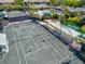 Overhead view of active tennis courts with players, seating, and scenic landscaping at 1447 Landings Cir # 68, Sarasota, FL 34231