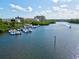 Picturesque waterfront featuring boat docks with multiple boats, set against a backdrop of buildings and lush greenery at 1447 Landings Cir # 68, Sarasota, FL 34231