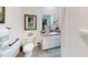 Bright half bathroom with white cabinets, granite countertop, and framed artwork on the wall at 1790 White Orchid Ct, Sarasota, FL 34235