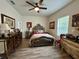 Well-lit bedroom with a queen-size bed and antique furniture at 1790 White Orchid Ct, Sarasota, FL 34235