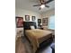 Cozy bedroom featuring a neutral color scheme, ceiling fan, and framed art on the walls at 1790 White Orchid Ct, Sarasota, FL 34235