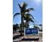 Lido Beach Pool & Pavilion community sign framed by tall palm trees against a bright blue sky at 1790 White Orchid Ct, Sarasota, FL 34235