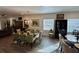 A spacious dining room features a chandelier, a glass table with seating, and view to the living room at 1790 White Orchid Ct, Sarasota, FL 34235