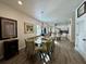 A spacious dining room features a chandelier, a glass table with seating, and an open view to the kitchen at 1790 White Orchid Ct, Sarasota, FL 34235