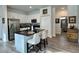 Bright kitchen featuring white cabinets, stainless steel appliances, and a black countertop island with barstool seating at 1790 White Orchid Ct, Sarasota, FL 34235