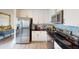 Kitchen area featuring stainless steel appliances, black countertops, and white cabinets at 1790 White Orchid Ct, Sarasota, FL 34235