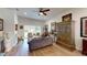 Bright living room with hardwood floors, ceiling fan, and sliding glass doors to backyard at 1790 White Orchid Ct, Sarasota, FL 34235