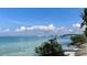 Scenic view of a clear waterway with city skyline under a beautiful blue sky with clouds at 1790 White Orchid Ct, Sarasota, FL 34235