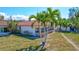 Manicured backyard with well maintained lawn, landscaping, and tile roof at 185 Vista Hermosa Circle, Sarasota, FL 34242