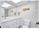 Bright bathroom with large mirror, marble countertop, and modern toilet at 185 Vista Hermosa Circle, Sarasota, FL 34242