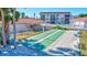 Community shuffleboard courts with pool and buildings in background at 185 Vista Hermosa Circle, Sarasota, FL 34242