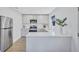 Bright kitchen with stainless steel appliances, modern white cabinetry, and quartz countertops at 185 Vista Hermosa Circle, Sarasota, FL 34242