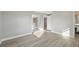 Bedroom with sliding glass doors that offer access to a balcony, light-colored walls, and wood floors at 2079 Pellam Blvd, Port Charlotte, FL 33948