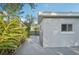 View of house from the backyard, with a side yard and some surrounding foliage at 2079 Pellam Blvd, Port Charlotte, FL 33948