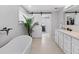 Bathroom features a freestanding tub, double vanity, and barn door at 221 Lychee Rd, Nokomis, FL 34275