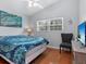 Cozy bedroom with hardwood floors and a comfy seating area at 221 Lychee Rd, Nokomis, FL 34275