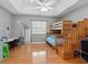 bedroom with bunk beds, a study area, and wood floors at 221 Lychee Rd, Nokomis, FL 34275