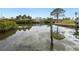 Serene canal view with lush vegetation and waterfront homes at 221 Lychee Rd, Nokomis, FL 34275