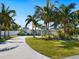 Charming coastal home with palm trees and a circular driveway at 221 Lychee Rd, Nokomis, FL 34275