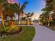 Luxury coastal home with palm trees and a long driveway at 221 Lychee Rd, Nokomis, FL 34275