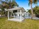 Relaxing gazebo with a view of the pool and lush landscaping at 221 Lychee Rd, Nokomis, FL 34275