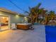 Modern hot tub with surrounding patio and pool view at 221 Lychee Rd, Nokomis, FL 34275