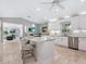 Open concept kitchen boasts granite countertops and stainless steel appliances at 221 Lychee Rd, Nokomis, FL 34275