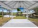 Outdoor entertainment space with pergola, TV, and waterfront views at 221 Lychee Rd, Nokomis, FL 34275